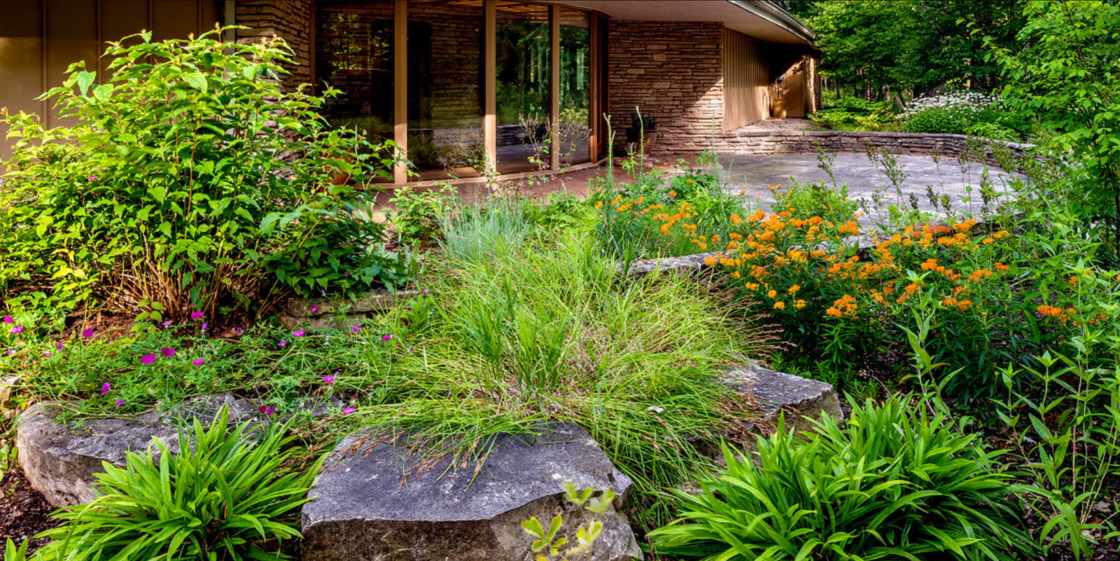 Garden with flowers and rocks in front of a house
